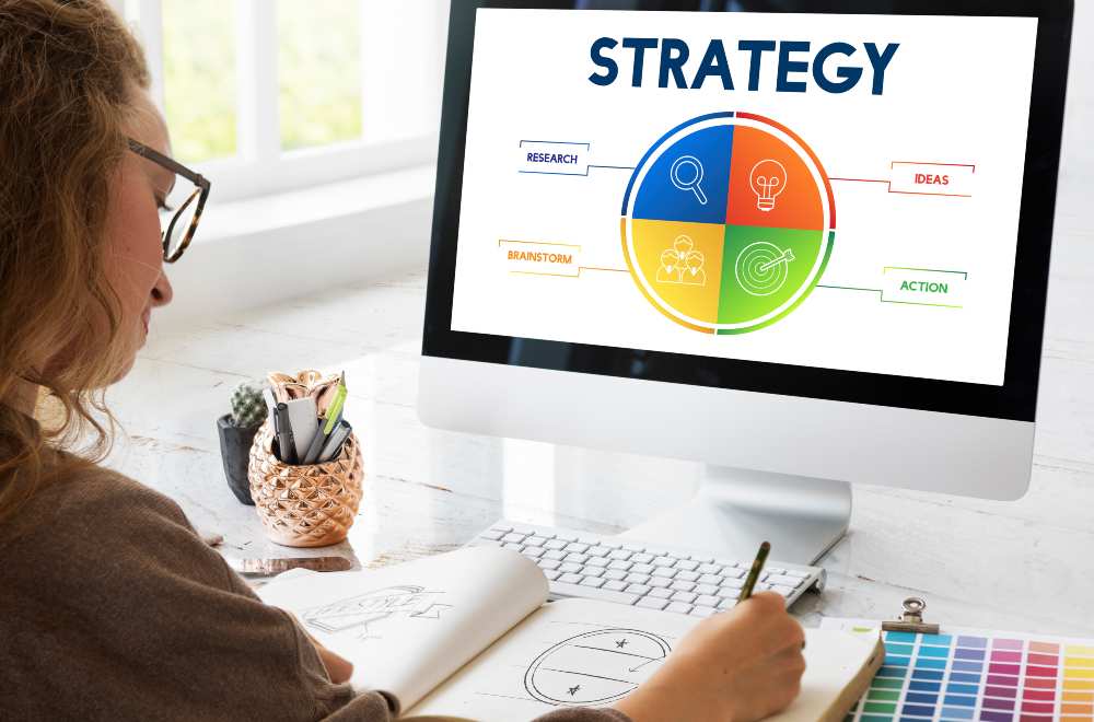 Woman working on a laptop, brainstorming ideas for digital marketing strategies.